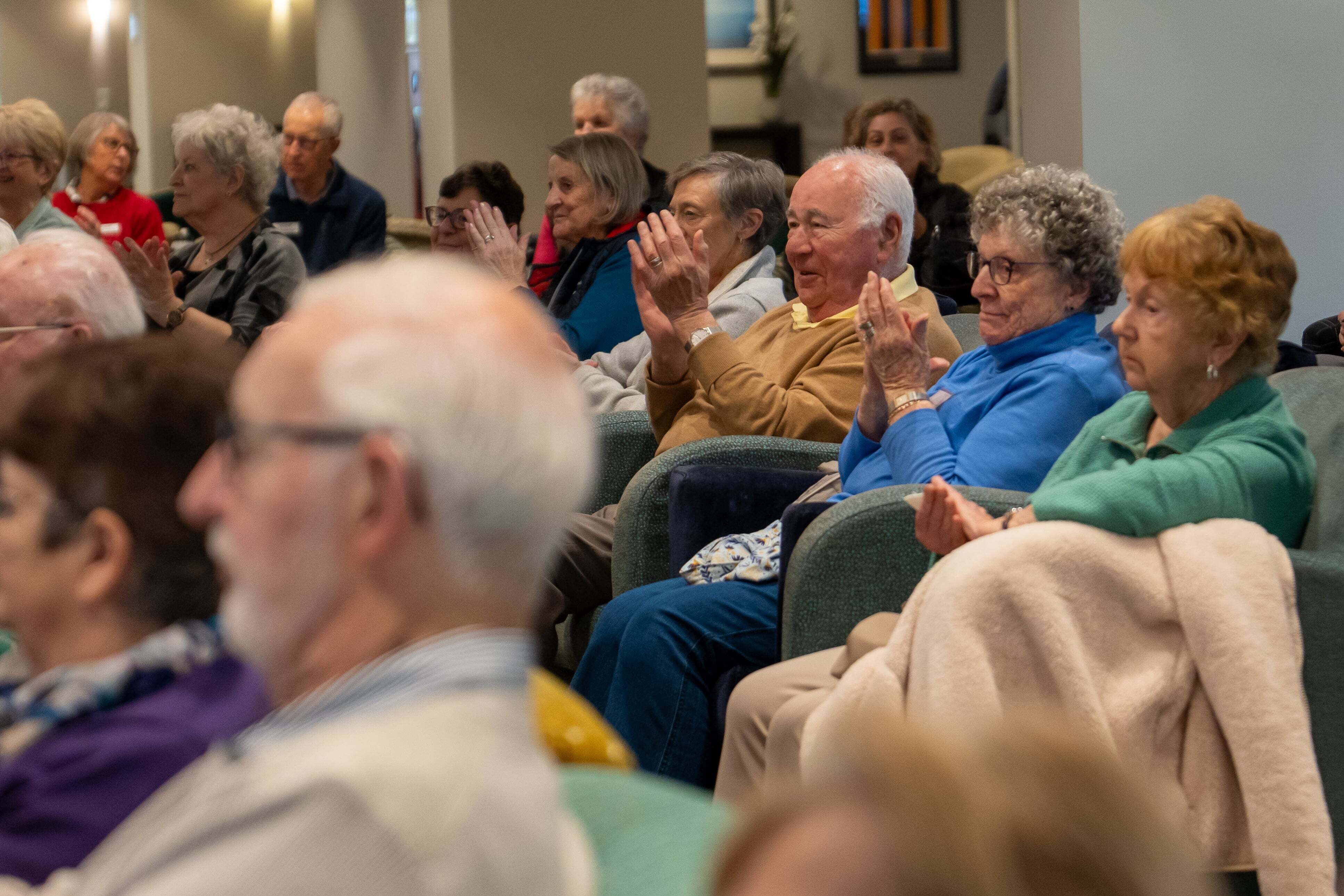 Residents at Nellie Melba Village applaud the new charity partner announcement
