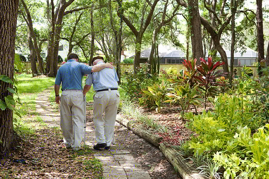 Son walking with elderly father