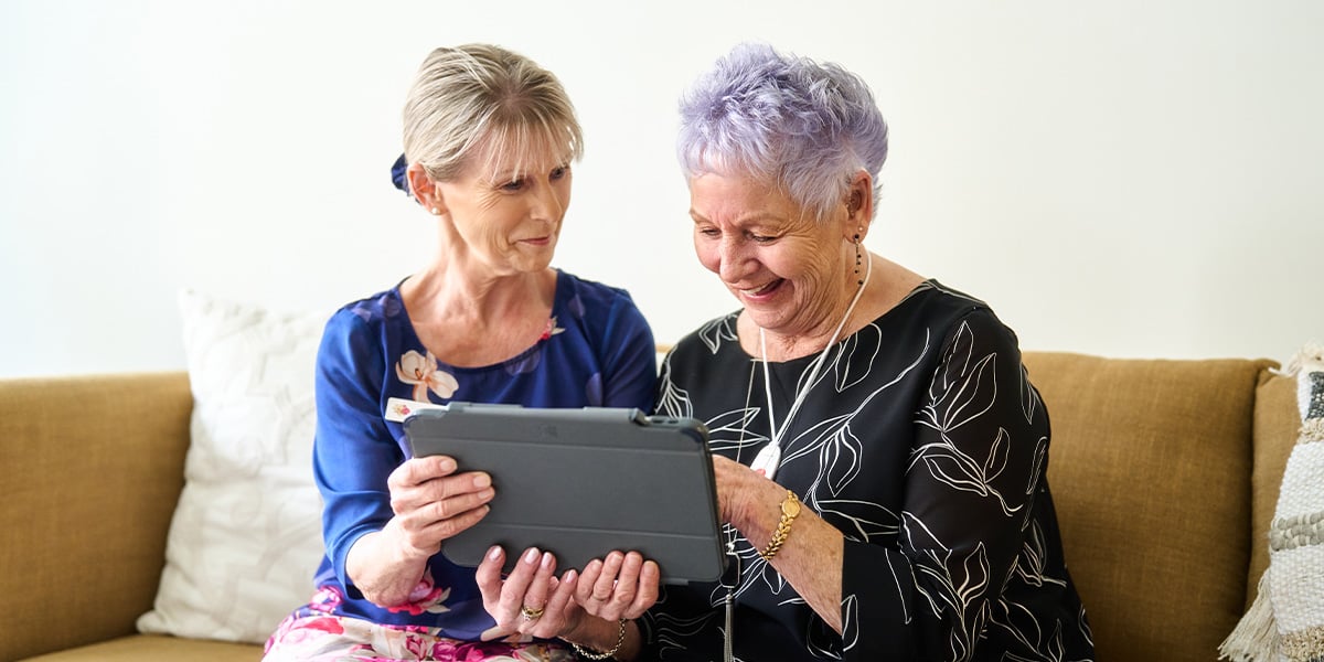 resident looking at a tablet