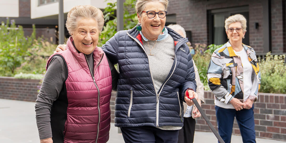 three residents walking in the village